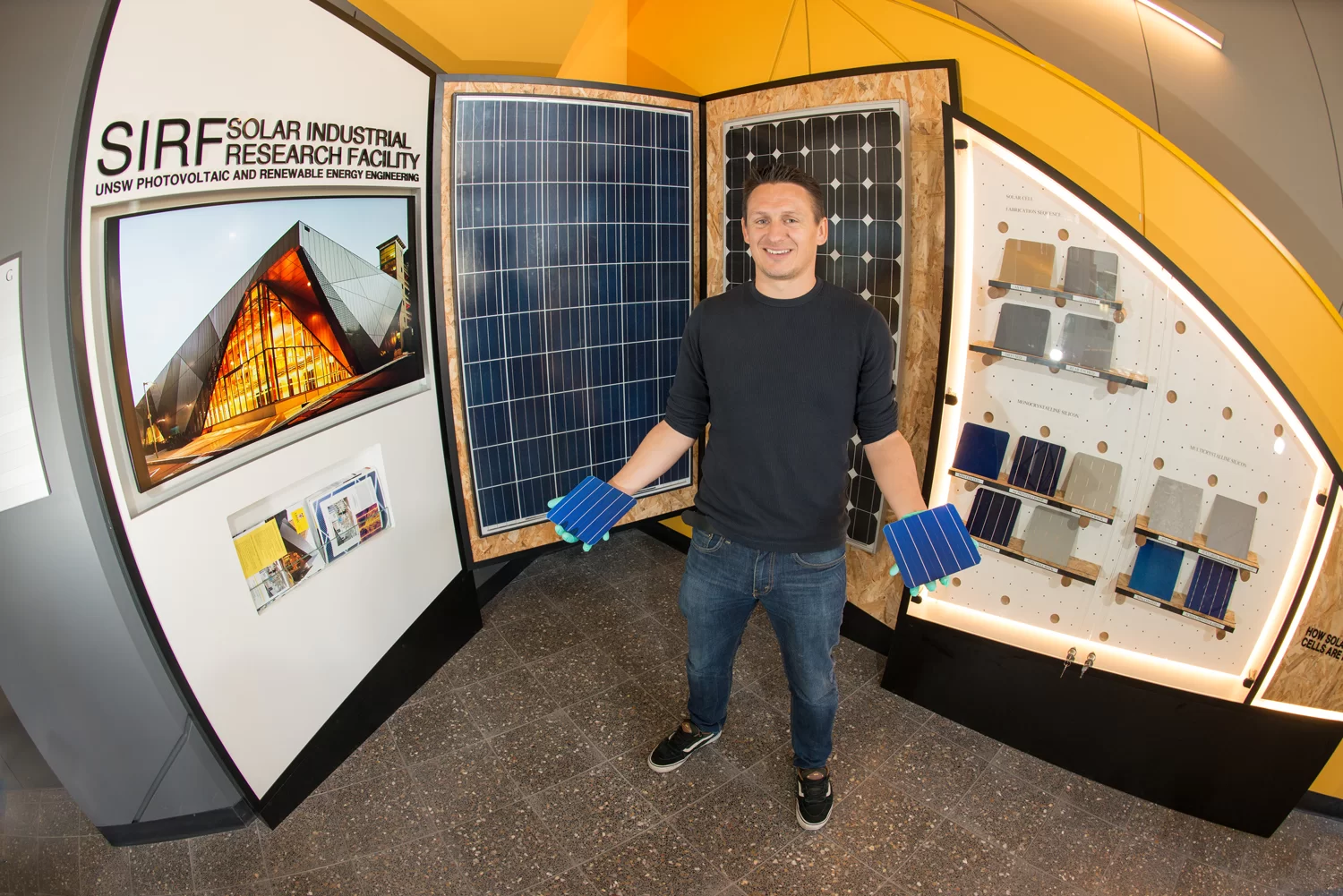 Brett Hallam holding silicon solar cells at UNSW’s Solar Industrial Research Facility
