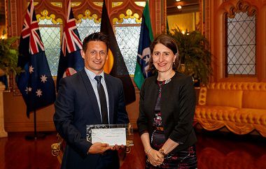 Brett Hallam receiving his award with NSW Premier Gladys Berejiklian in 2017